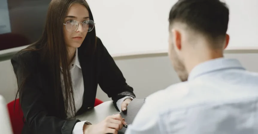Professional woman in business attire consulting with client during probate attorney Florida consultation meeting.