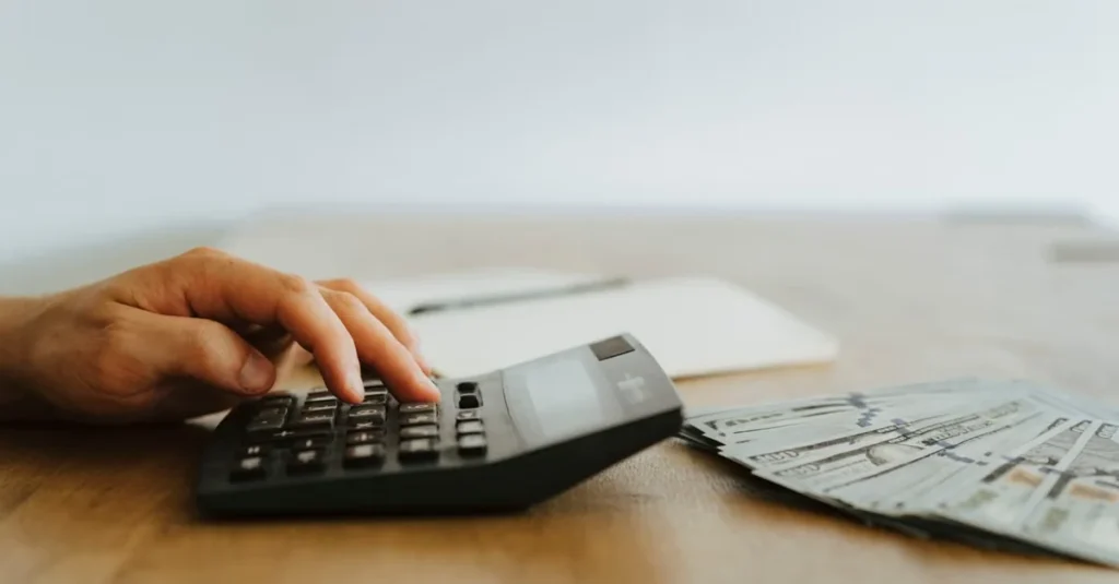 Hand using calculator with financial documents on desk for Florida estate planning preparation.