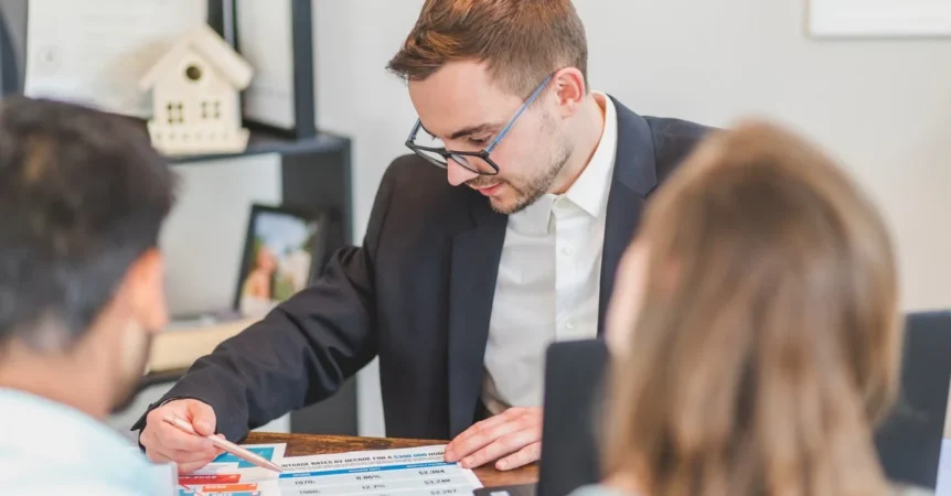 Professional advisor reviewing high net worth estate planning documents with clients in office meeting.