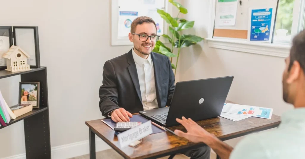 Professional meeting between estate attorney and client discussing probate requirements at modern office desk.