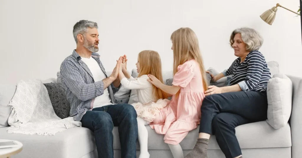 Multigenerational family sitting on couch playing together, illustrating estate planning legacy decisions.