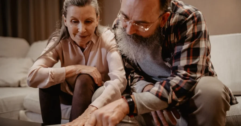 Mature couple reviewing documents together on sofa for estate planning legacy and financial future decisions.