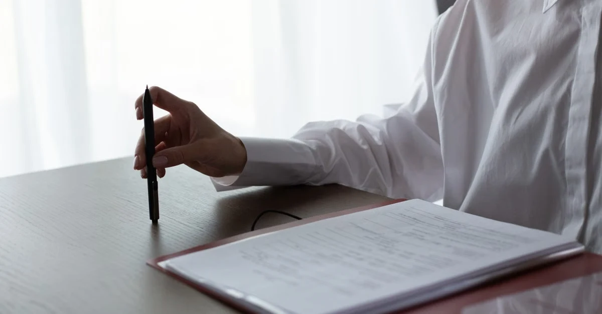 Professional signing estate planning documents with pen at desk, legacy planning mistake concept.