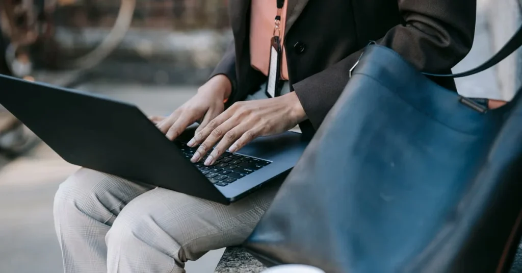 Professional with laptop and briefcase reviewing estate planning attorney services outdoors in Florida.