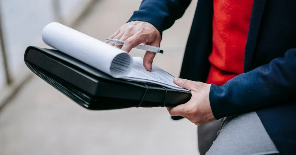 Professional reviewing trust documents and blueprints to understand revocable vs irrevocable trust differences.